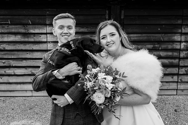 Couple with dog at wedding ceremony.