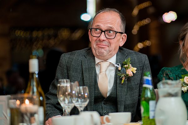 Man at wedding reception making a funny face.