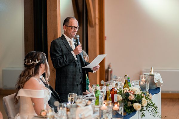 Man giving speech at wedding reception.