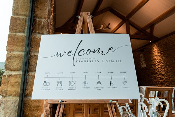 Wedding welcome sign with schedule for Kimberley and Samuel.