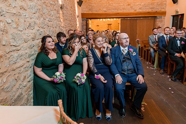 Wedding guests emotional during ceremony.