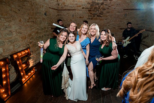 Group of women celebrating at wedding reception.