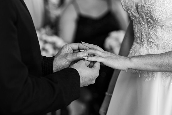 Bride and groom exchanging wedding rings.