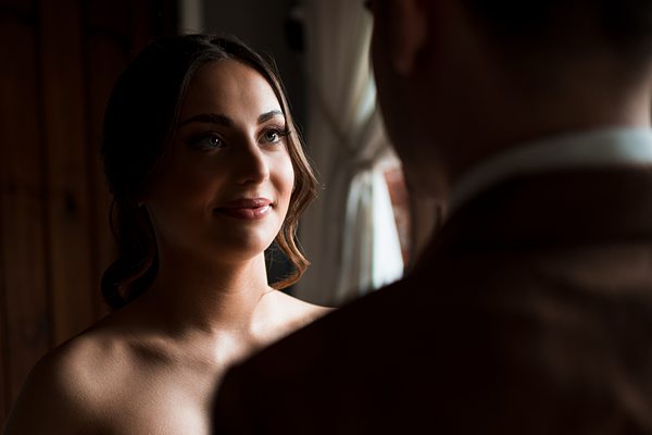 Bride gazing at groom, intimate wedding moment.