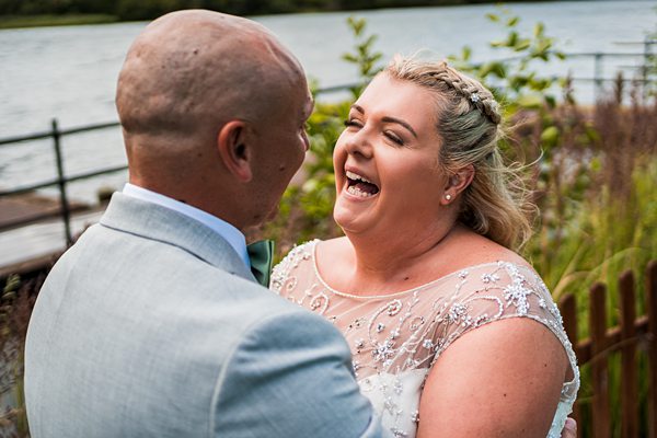 Joyful bride laughing with groom outdoors