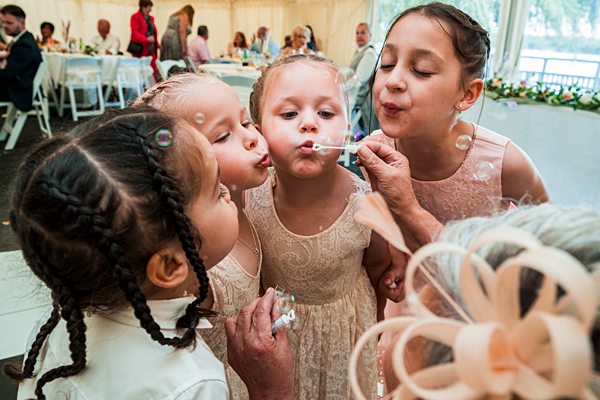 Children blowing bubbles at event
