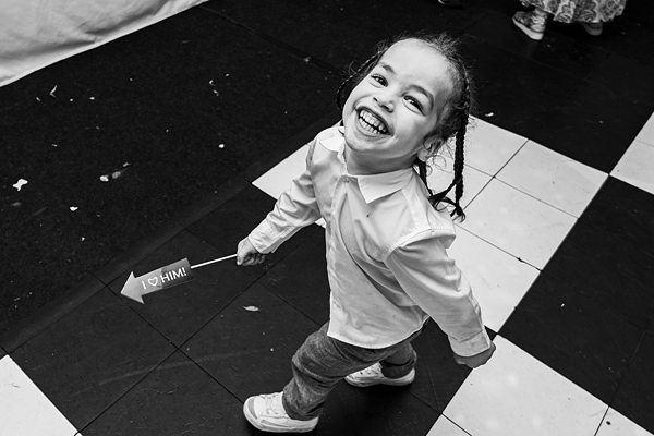 Joyful child playing on checkered floor.