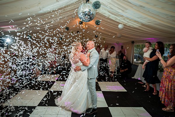 Couple's first dance with confetti at wedding reception.
