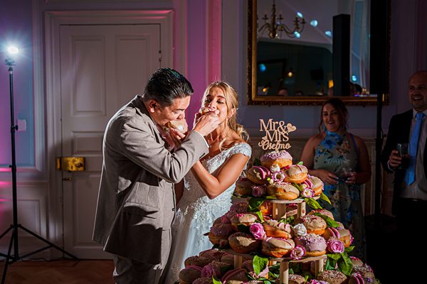 Bride and groom sharing cake at wedding reception.