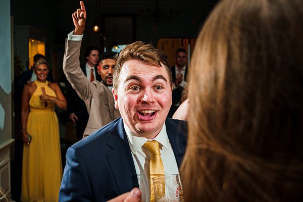 Man dancing excitedly at festive event.