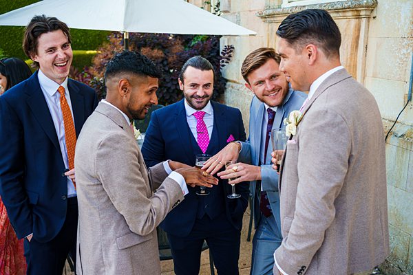 Men toasting at an outdoor wedding reception.