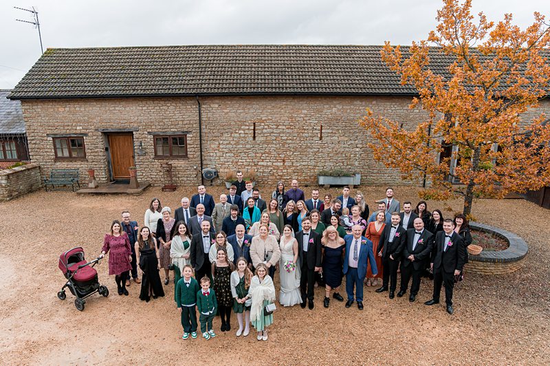 Group of people at countryside wedding gathering.