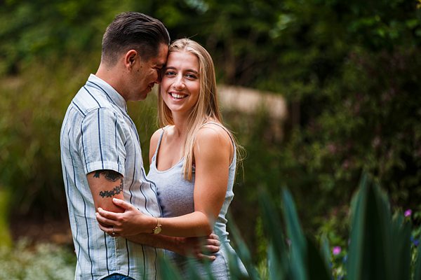 Couple embracing happily in a garden setting