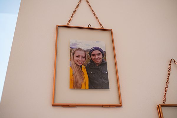 Framed photo of smiling couple on wall.