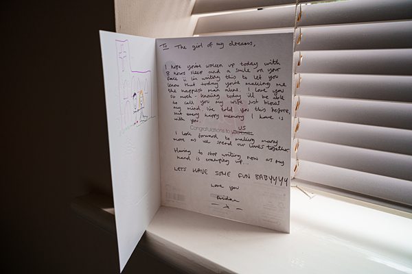 Greeting card with heartfelt message by window blinds.
