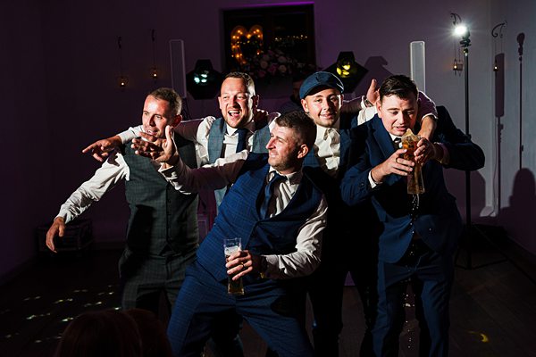 Group of men enjoying a lively party indoors.