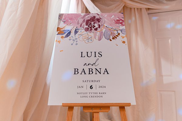 Wedding sign with names and date on easel.