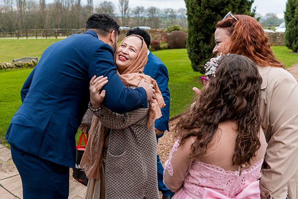 Outdoor family wedding embrace with joy.