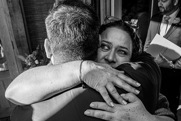 Emotional embrace at an event, black and white photo.