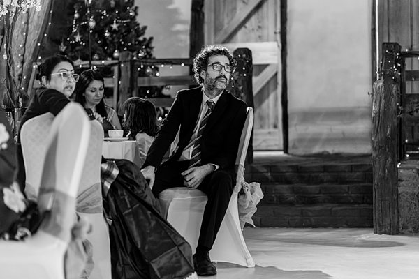 Man pondering at festive event in monochrome.