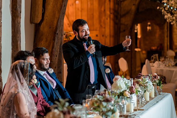 Man giving toast at wedding reception.