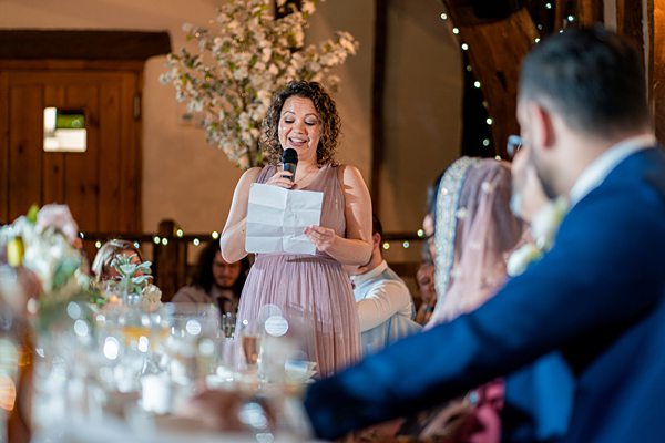 Woman giving speech at wedding reception.