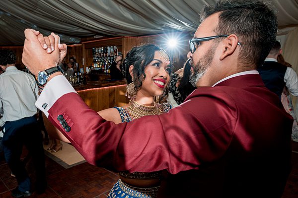 Couple dancing at festive event.