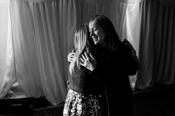 Two women embracing warmly in a black and white photo.