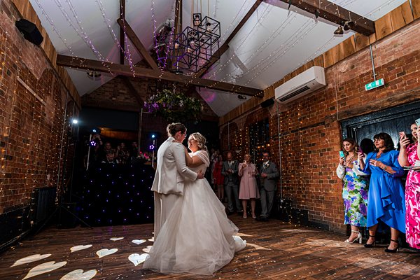 Couple's first dance at rustic wedding venue.