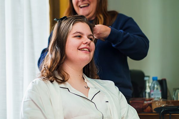 Woman smiling during hairdressing session.