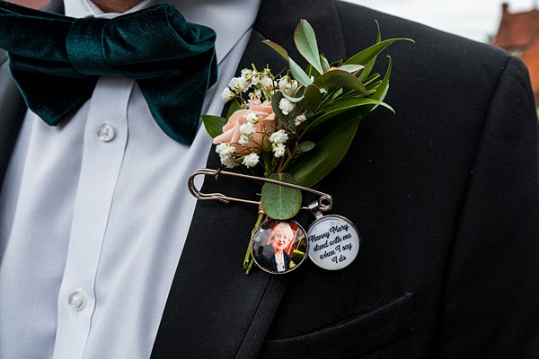 Groom's suit with boutonniere and memorial photo pin.