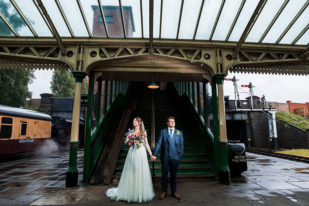 Bride and groom at vintage railway station