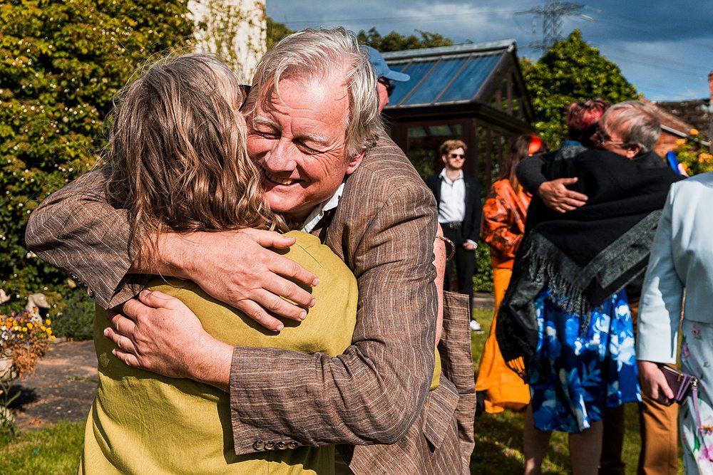 People hugging at an outdoor gathering