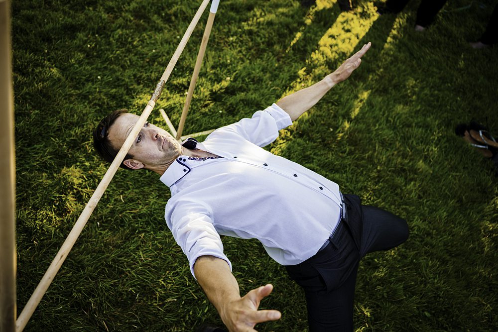 Man doing limbo dance on grass
