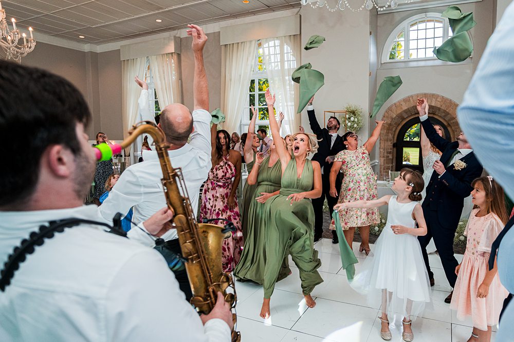 Wedding celebration with dancing and live saxophonist.