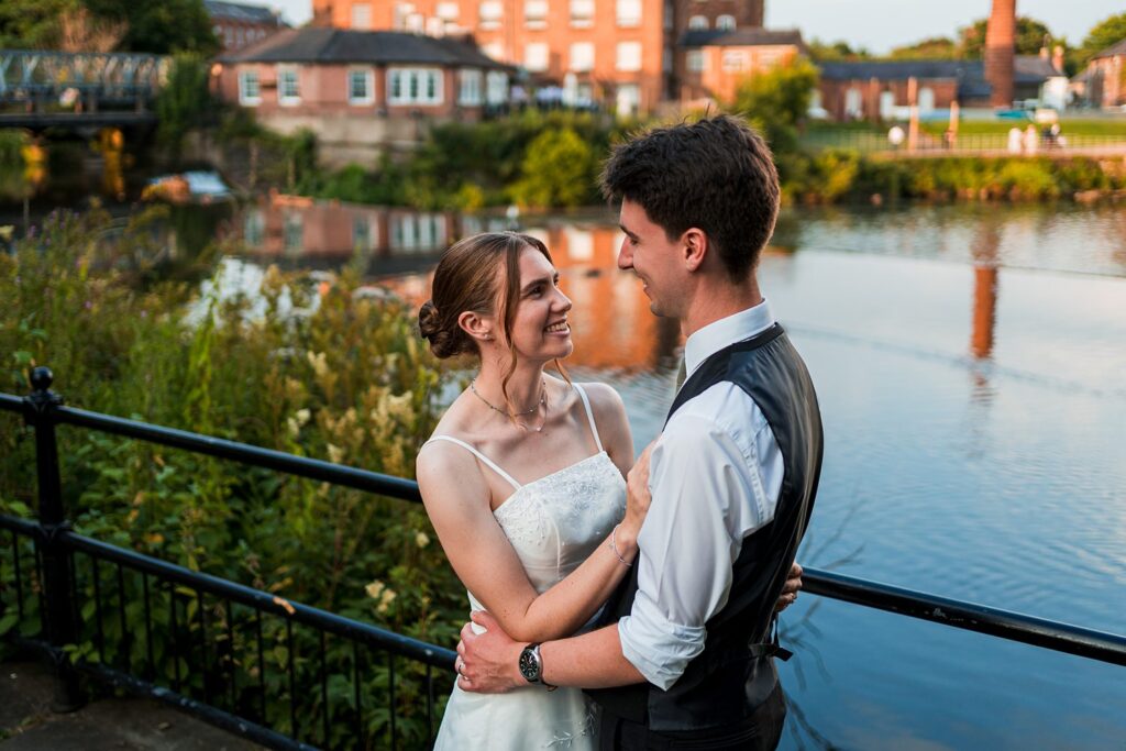 Couple embracing by riverside in evening