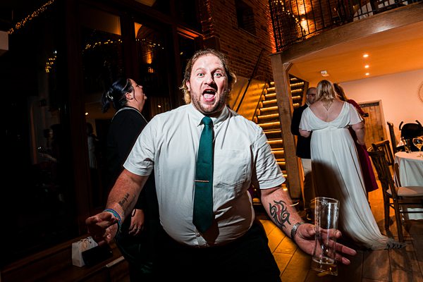 Man celebrating at lively wedding reception