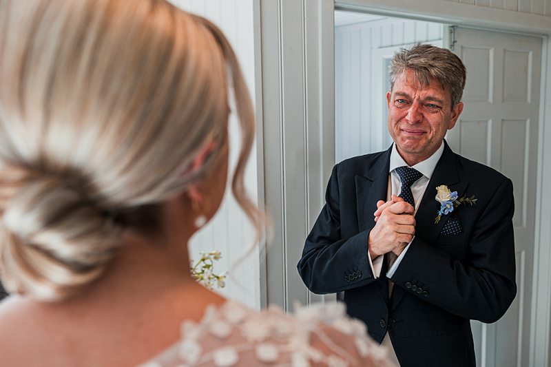 Father sees daughter in wedding dress, emotional moment