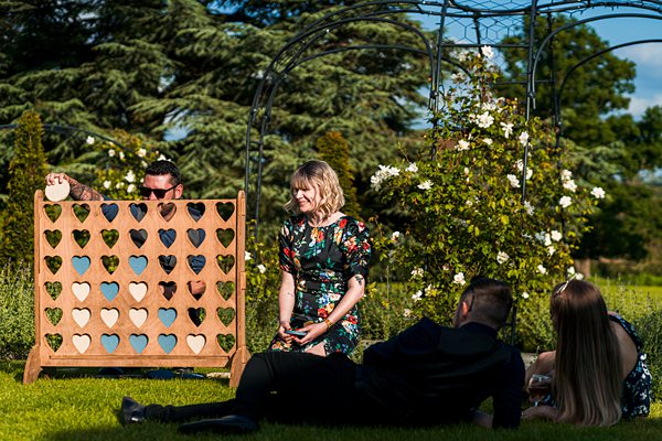 Garden gathering with Connect Four game.