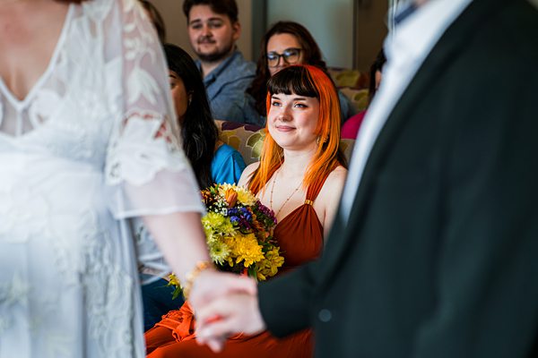 Wedding ceremony with colourful floral bouquet.