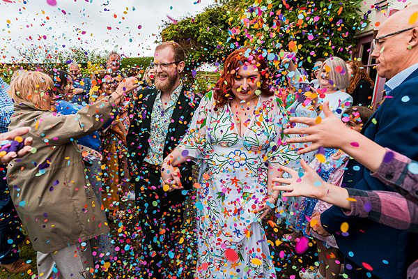 Colourful confetti shower at a joyful wedding celebration.