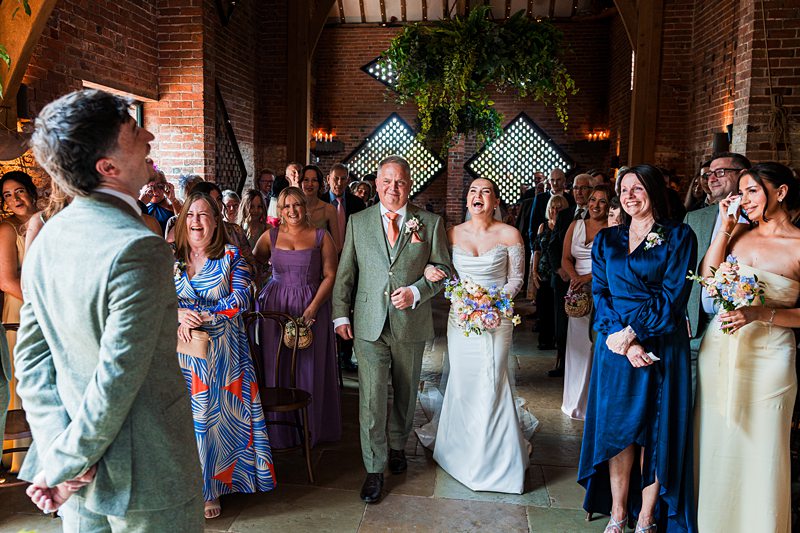 Joyful wedding ceremony with laughing bride and groom.