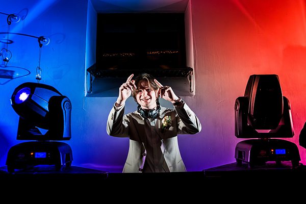 DJ playing music under colourful lights