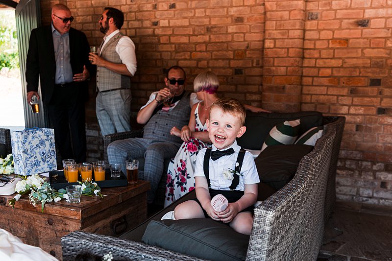 Smiling child at a garden party with adults.