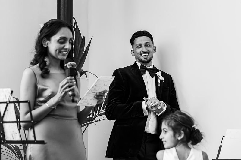 Wedding speech with smiling guests and child.