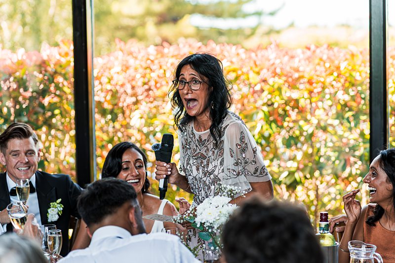 Person giving a speech at a wedding reception.