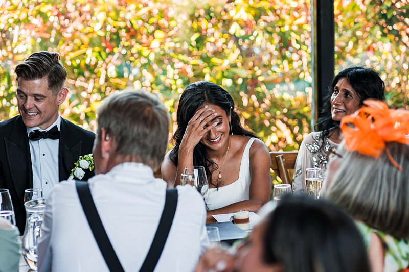 Wedding guests laughing and enjoying reception.