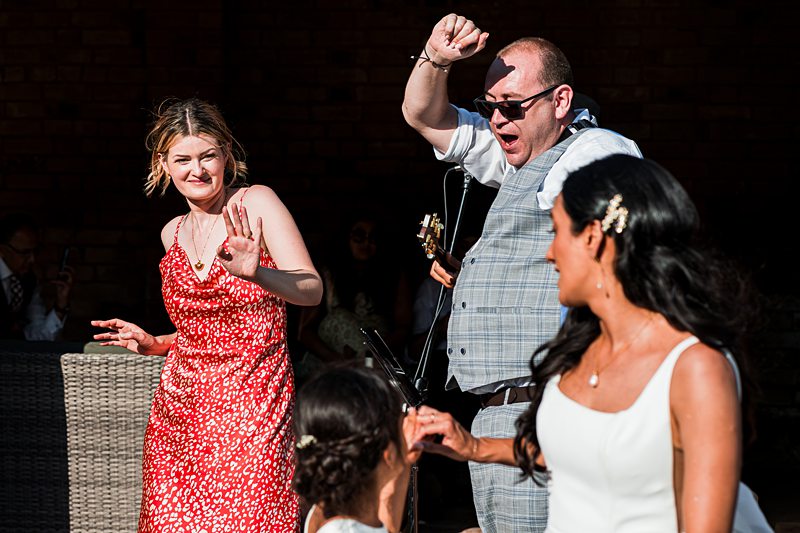People dancing joyfully at an outdoor event.