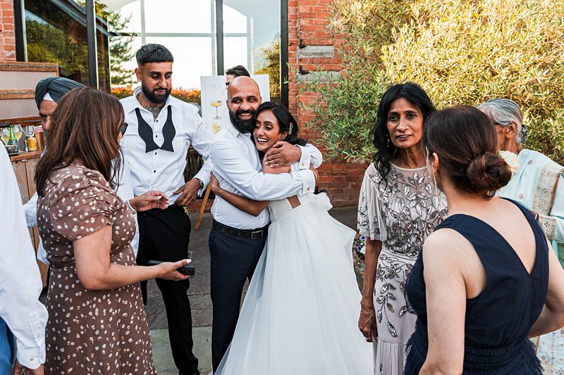Group celebrating at a wedding outdoors.