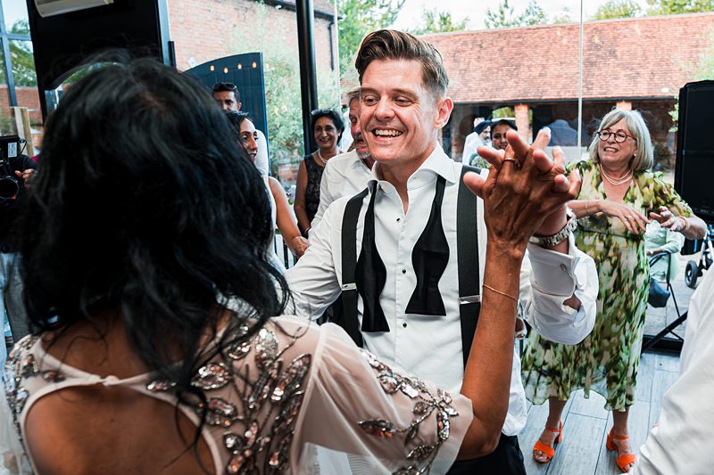 People dancing joyfully at a celebration event.